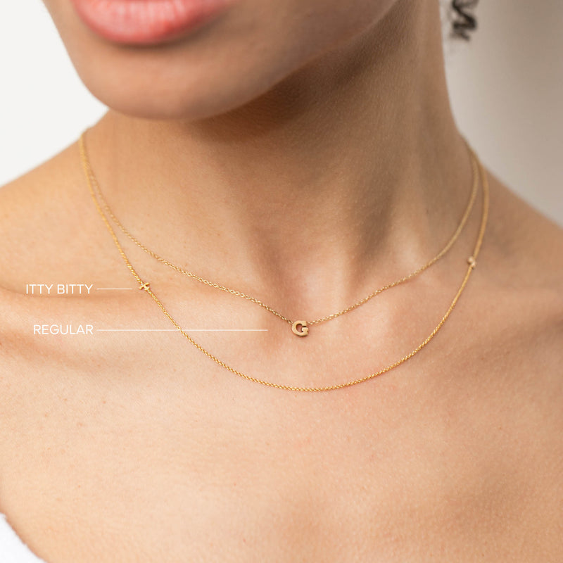 comparison image of woman wearing two different sizes of Zoe Chicco 14k gold initial letter necklaces