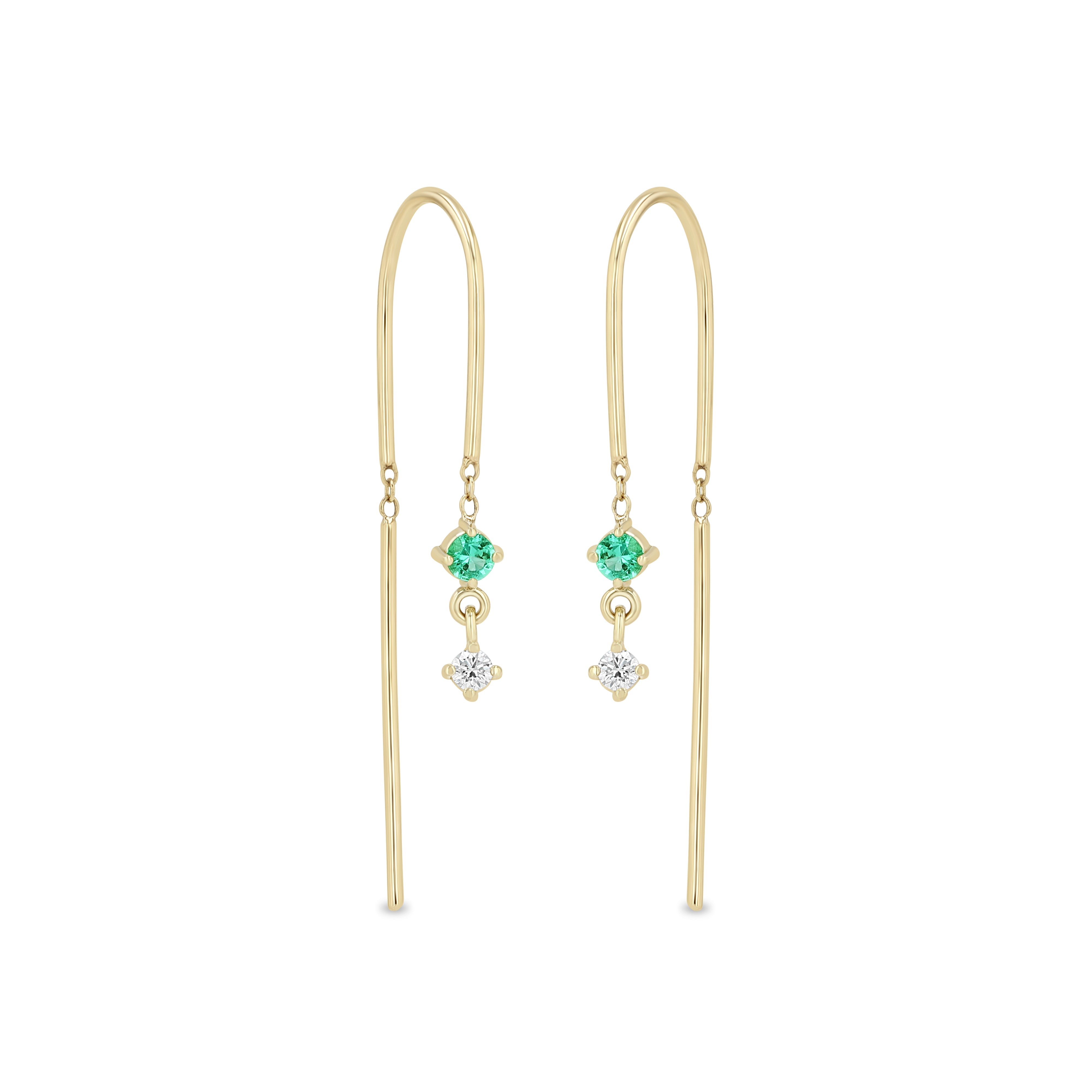 Zoe Chicco 14k gold wire dangle earrings with a white diamond and emerald on a white background