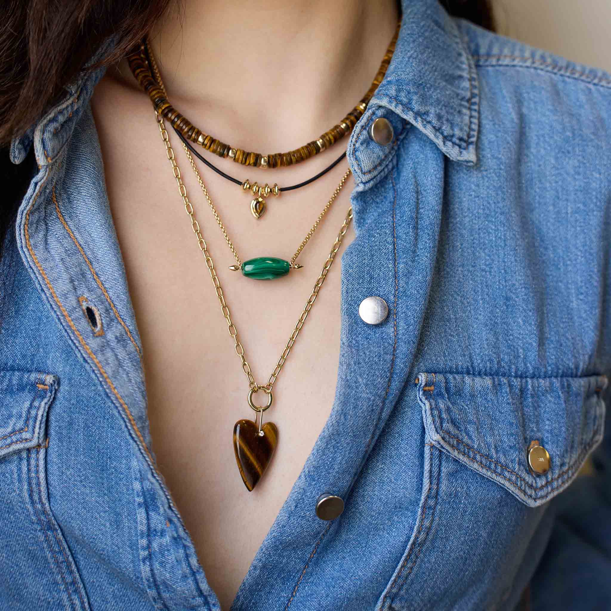 Person wearing layered necklaces with a denim jacket featuring 14k Malachite Barrel Bead Small Box Chain Necklace