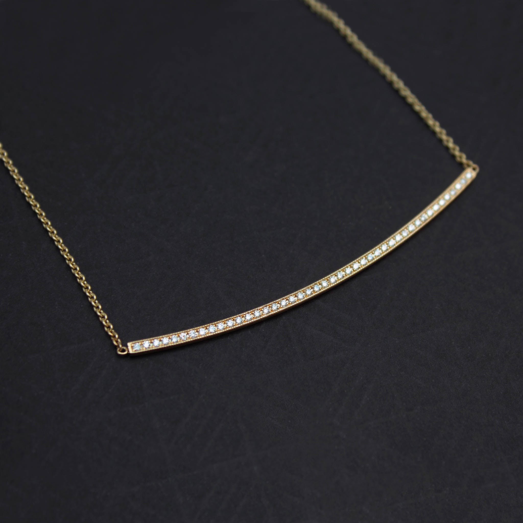 14k Pavé Diamond Long Curved Bar Necklace on a black background