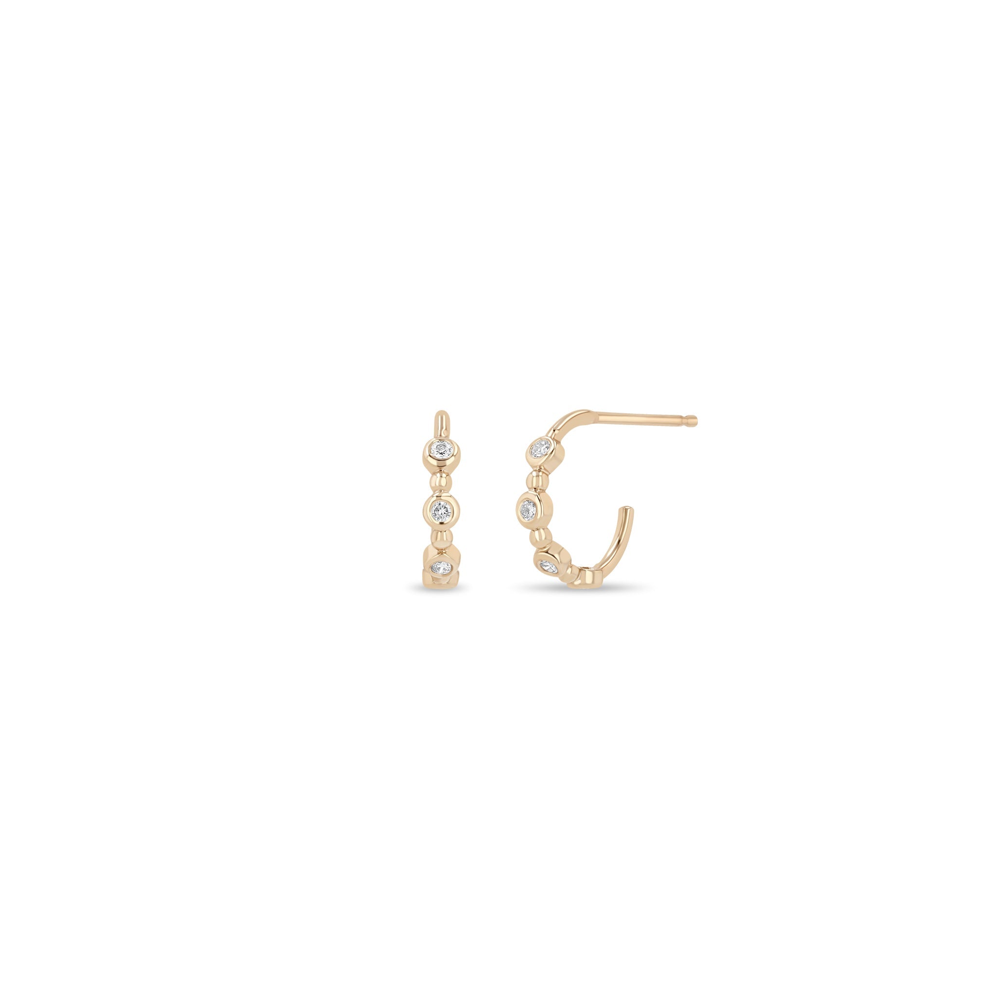 Zoe Chicco 14k rose gold huggie hoops with small diamonds on a white background