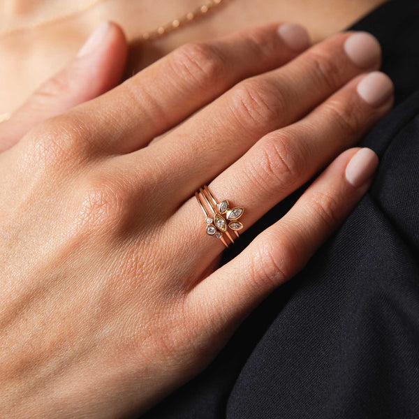 woman's hand with 14k Delicate Diamond Three Stackable Ring Set