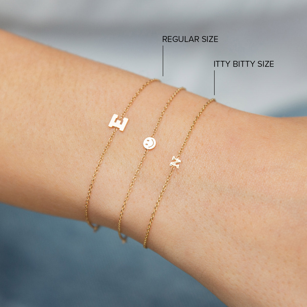 woman's wrist wearing Zoë Chicco 14kt Gold Initial Letter Chain Bracelet