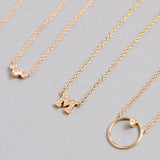 flat lay of Zoe Chicco 14kt Gold Pave Diamond Letter Pendant Necklace with a Medium Circle Prong DIamond Necklace