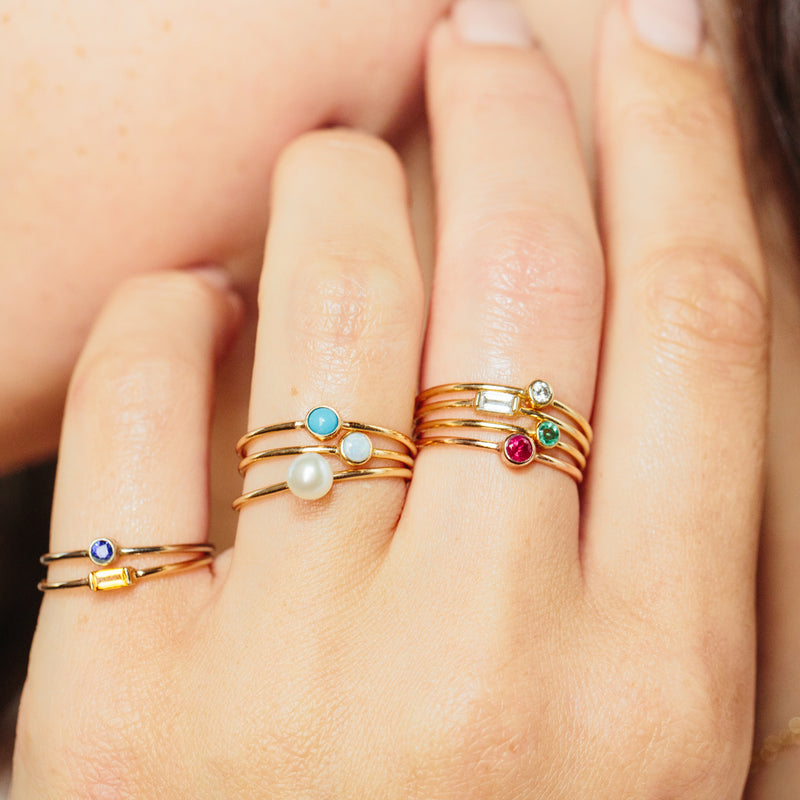 woman's hand wearing Zoë Chicco 14kt Gold Large Bezel Set Turquoise Ring | December Birthstone stacked with other Birthstone rings