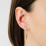 close up of woman wearing Zoë Chicco 14kt Gold Double Ear Cuff with a Diamond Stud and two gold hoops