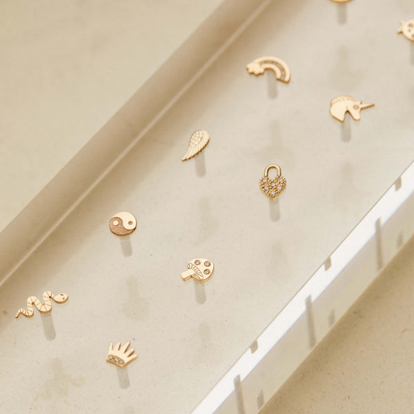 Zoë Chicco 14k Gold Itty Bitty Diamond Mushroom Stud Earring in an acrylic tray with other itty bitty earring styles