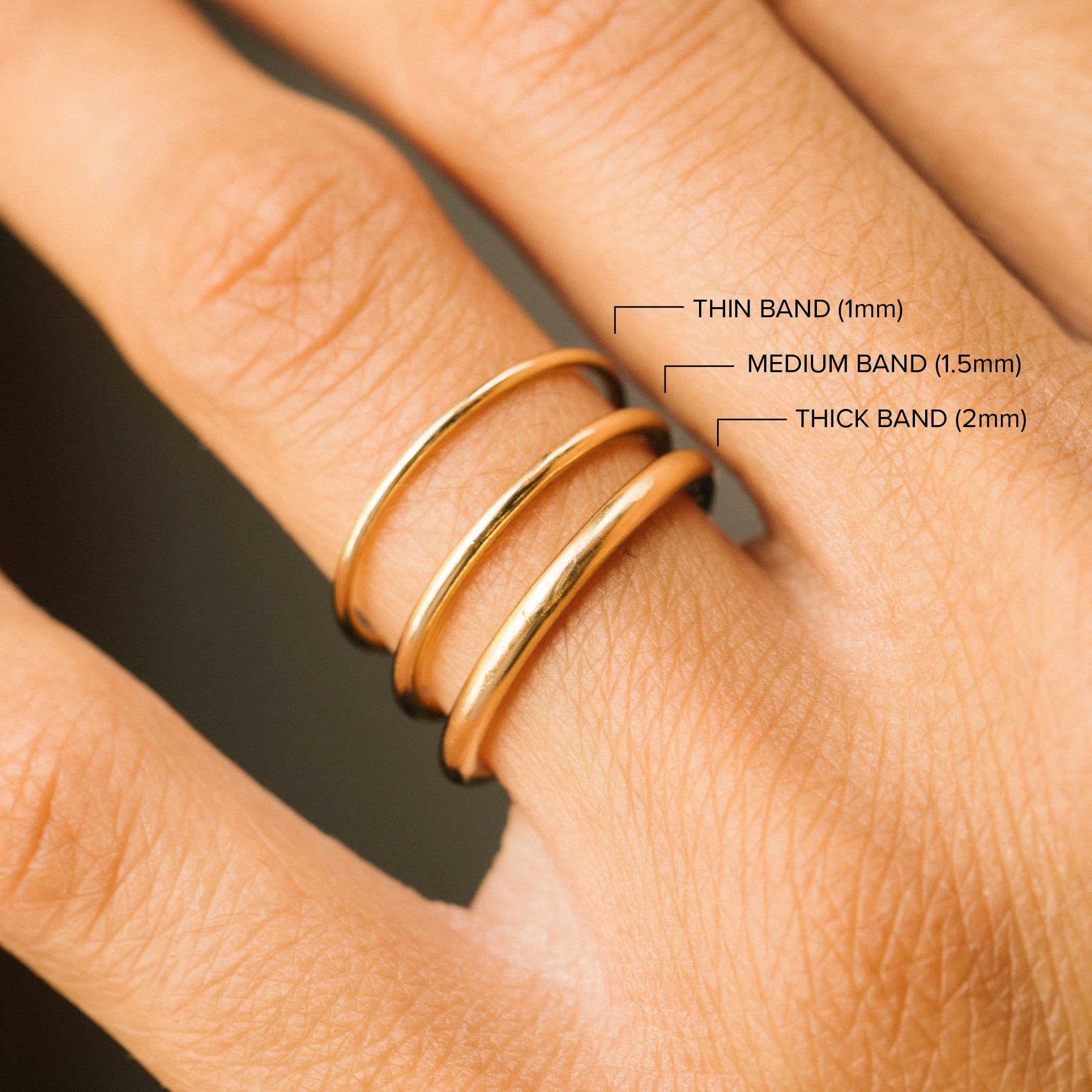 comparison image of a 1mm, 1.5mm and 2mm Zoë Chicco 14k Gold Classic Rounded Band Ring on a finger