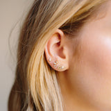 woman's ear wearing Zoe Chicco 14kt Gold Graduated Marquise Fan Stud, Marquise Diamond Stud, and Marquise Pave Diamond Halo Stud