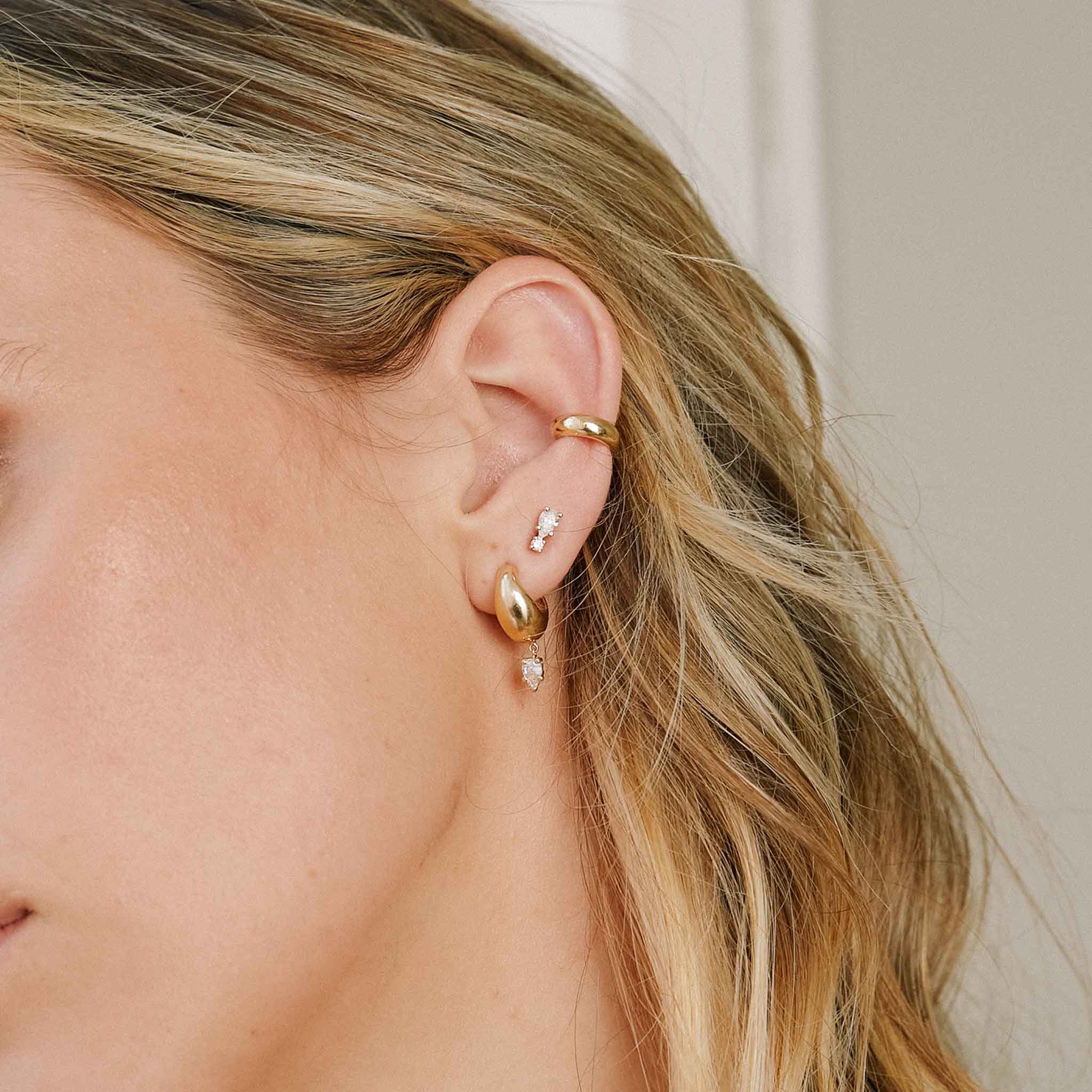 close up of a woman's ear wearing a Zoë Chicco 14k Gold Chubby Ear Cuff