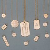 flat lay of Zoe Chicco 14 karat gold personalized charms and necklaces