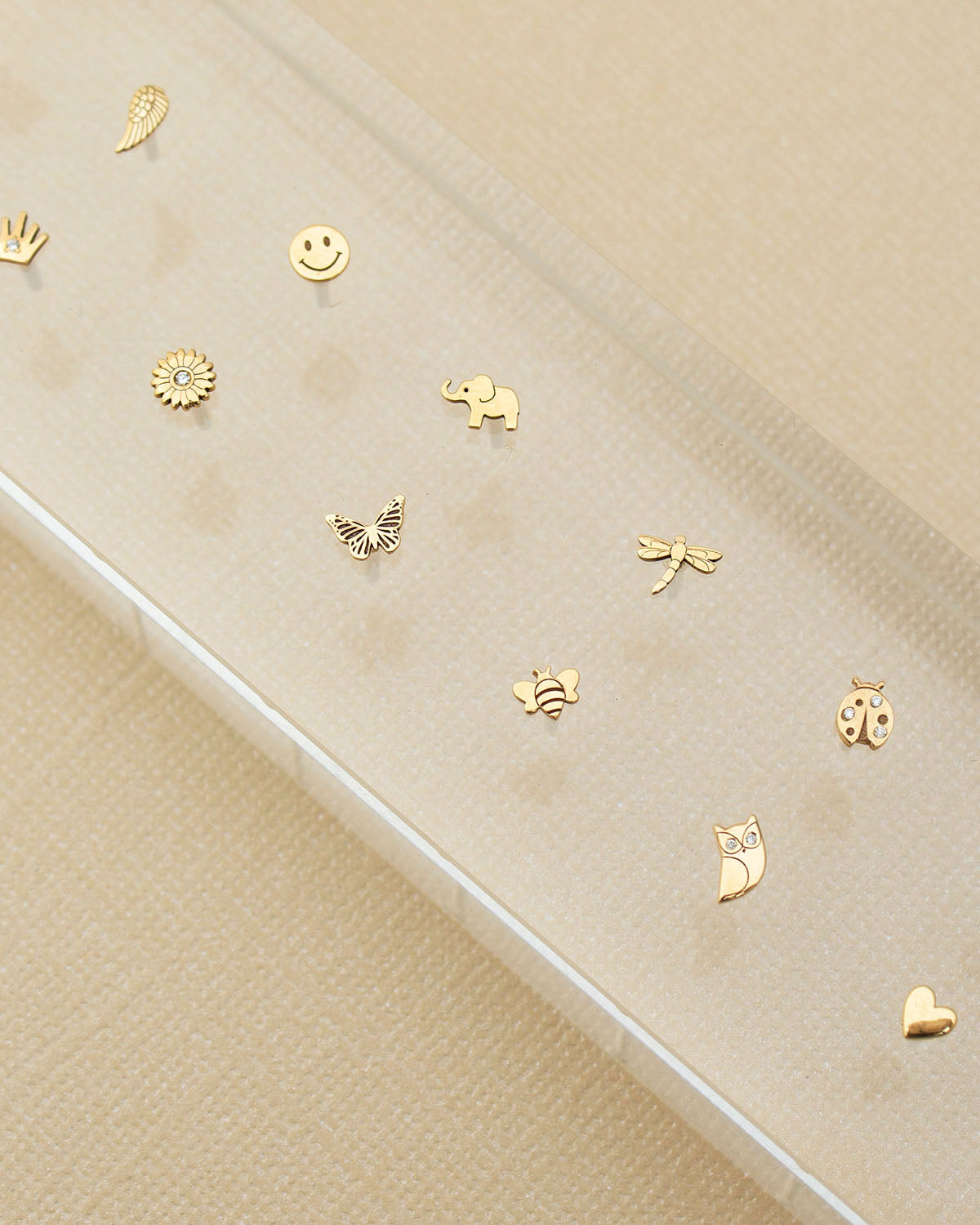 2025 Mother's Day Gift Guide - Under $450 - An array of itty bitty studs set on an acrylic bar