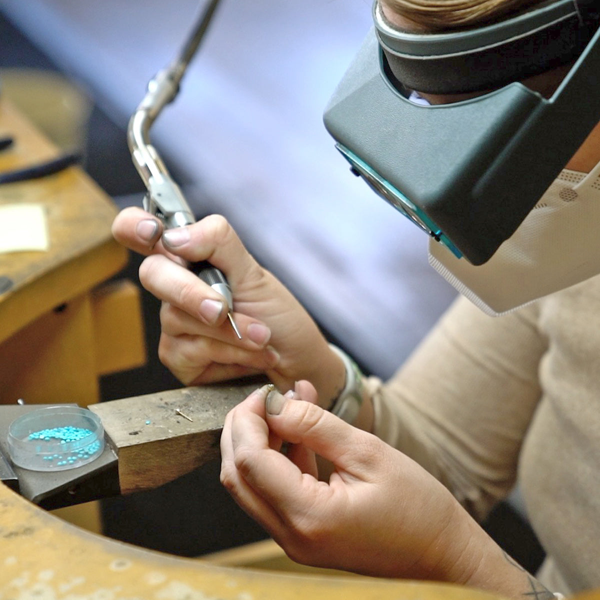 a bench jeweler at work in the Zoe Chicco studio