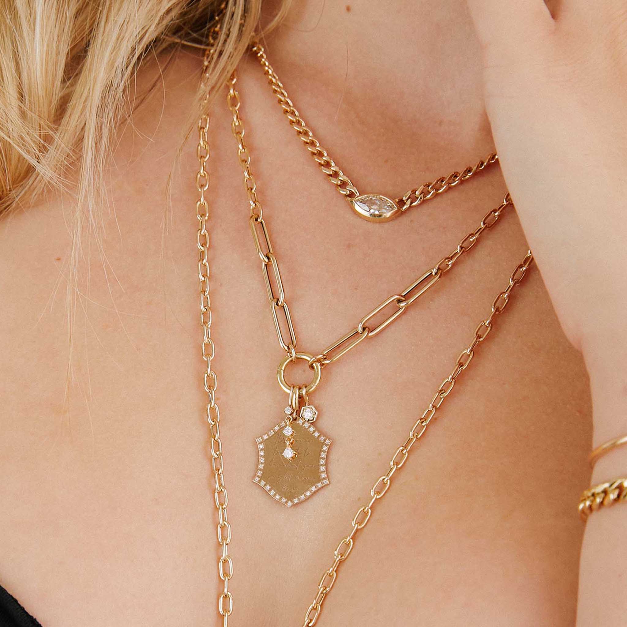 close up of woman wearing a Zoë Chicco 14k Gold Mixed Medium Square Oval & Large Paperclip Chain Round Enhancer Necklace with three charms attached