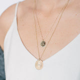 Woman wearing a Zoë Chicco 14k Gold Large Sunbeam Medallion Disc Charm Pendant on a long cable chain necklace