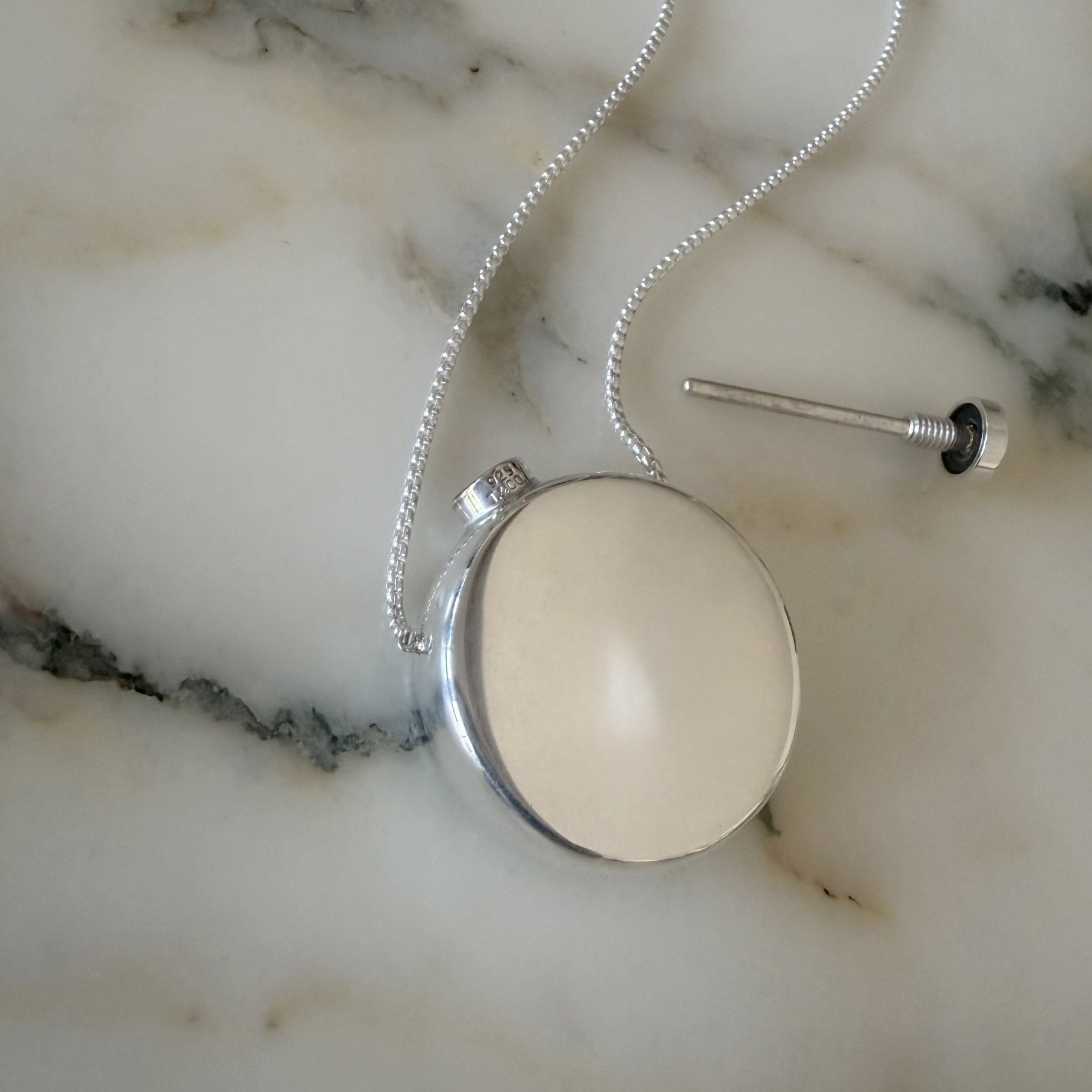 Zoe Chicco sterling silver perfume bottle chain necklace on a marble background