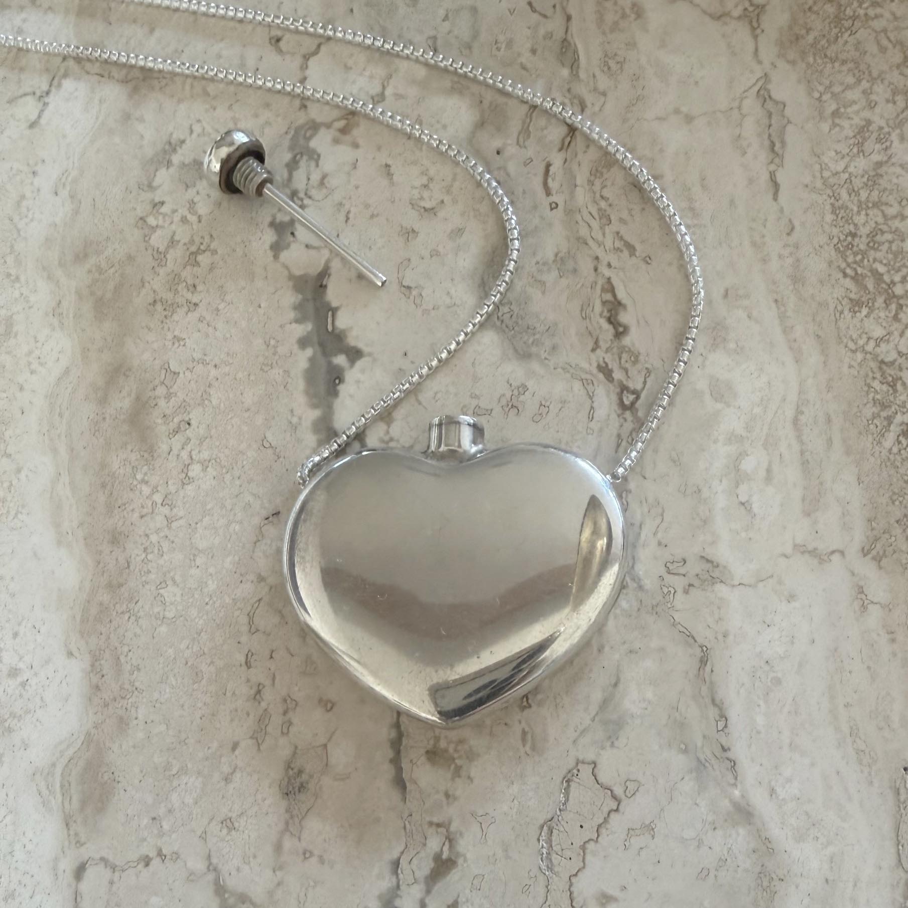 Zoe Chicco sterling silver heart-shaped perfume bottle chain necklace on a marble background