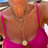 woman in pink top wearing a Zoë Chicco 14k Gold Large Pavé Diamond Oval Push Lock Enhancer attached onto a large paperclip chain necklace