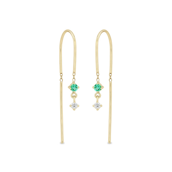 Zoe Chicco 14k gold wire dangle earrings with a white diamond and emerald on a white background