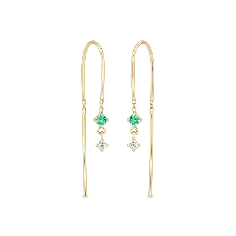 Zoe Chicco 14k gold wire dangle earrings with a white diamond and emerald on a white background