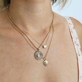 woman wearing a Zoë Chicco 14k Gold Pavé Diamond Hamsa Medium Sunbeam Medallion Clip On Charm Pendant dangling from a medium box chain necklace