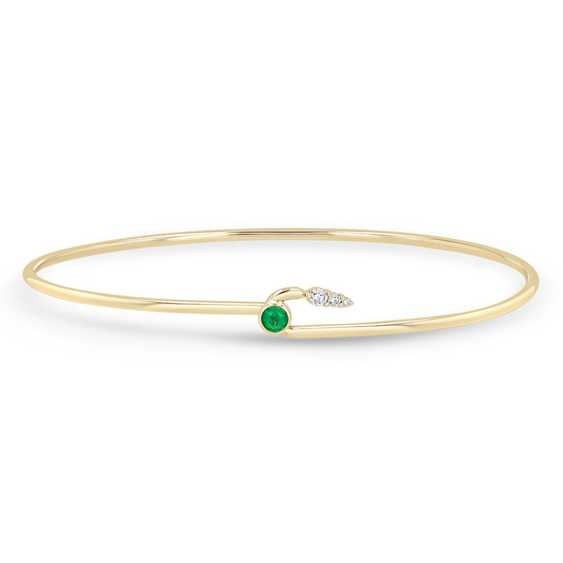 Zoe Chicco 14k gold wire cuff bracelet with a green emerald and 3 white diamonds on a white background