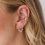 woman's ear wearing a Zoë Chicco 14k Gold Double Stud Small Mariner Chain Earring layered with a 14k Prong Diamond Small Mariner Link Stud and a 14k Gold & Pavé Diamond Double Row Ear Cuff and Chubby Ear Cuff