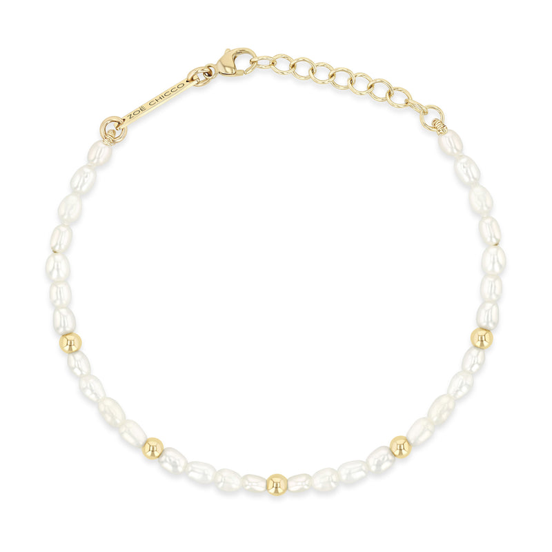 top down view of a Zoë Chicco 14k Gold Bead Station Rice Pearl Bracelet