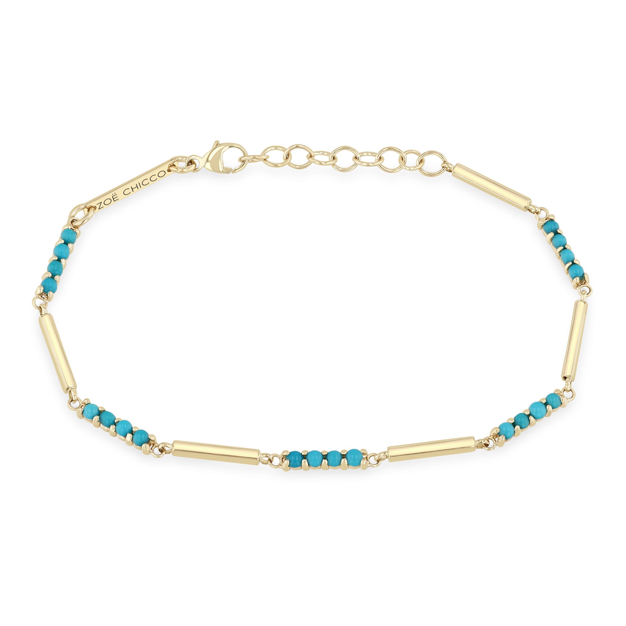 close up of a woman's wrist against a black background wearing a Zoë Chicco 14k Gold Mixed Gold & Turquoise Bar Bracelet