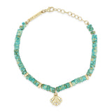 top down view of a Zoë Chicco 14k Gold & Light Turquoise Heishi Bead Seashell Charm Bracelet
