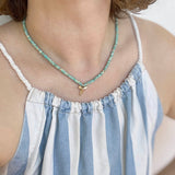 Zoe Chicco's 14k Gold & Light Turquoise Heishi Bead Shark's Tooth Charm Necklace on model