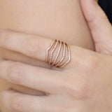 Close up of a hand wearing a Zoe Chicco 14k gold ring with pave diamonds