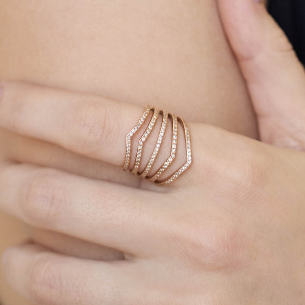 Close up of a hand wearing a Zoe Chicco 14k gold ring with pave diamonds