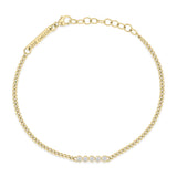 top down view of a Zoë Chicco 14k Gold 5 Diamond Bezel Bar XS Curb Chain Bracelet against a white background