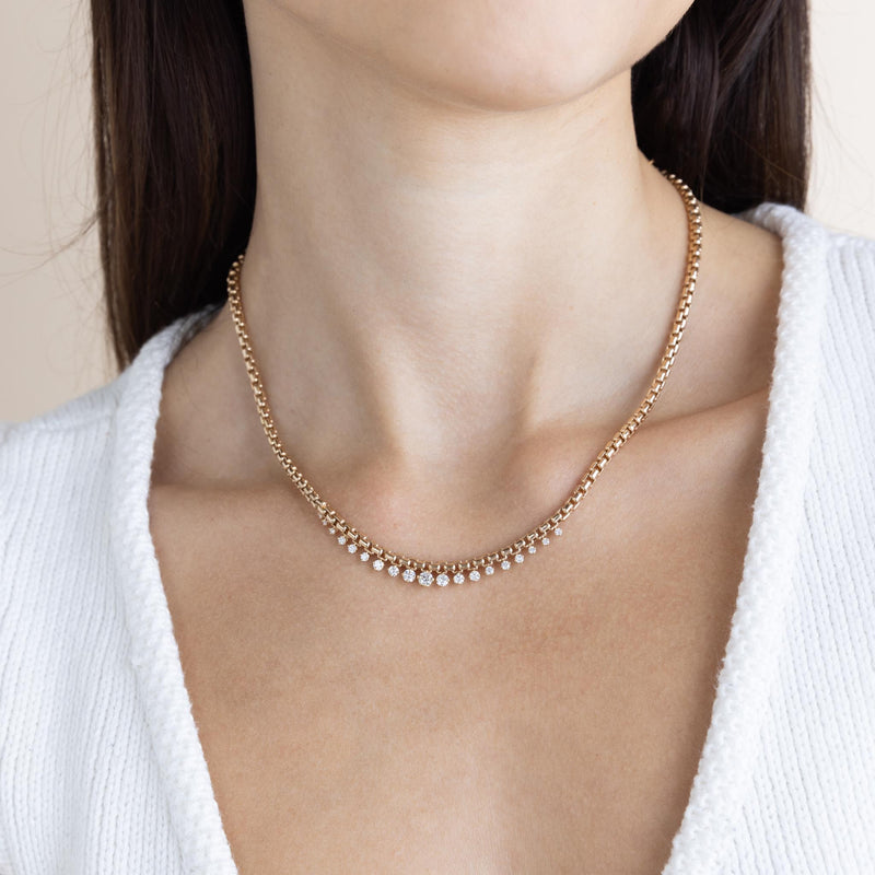 A woman wears Zoe Chicco's 14k Graduated Prong Diamond Large Box Chain Necklace