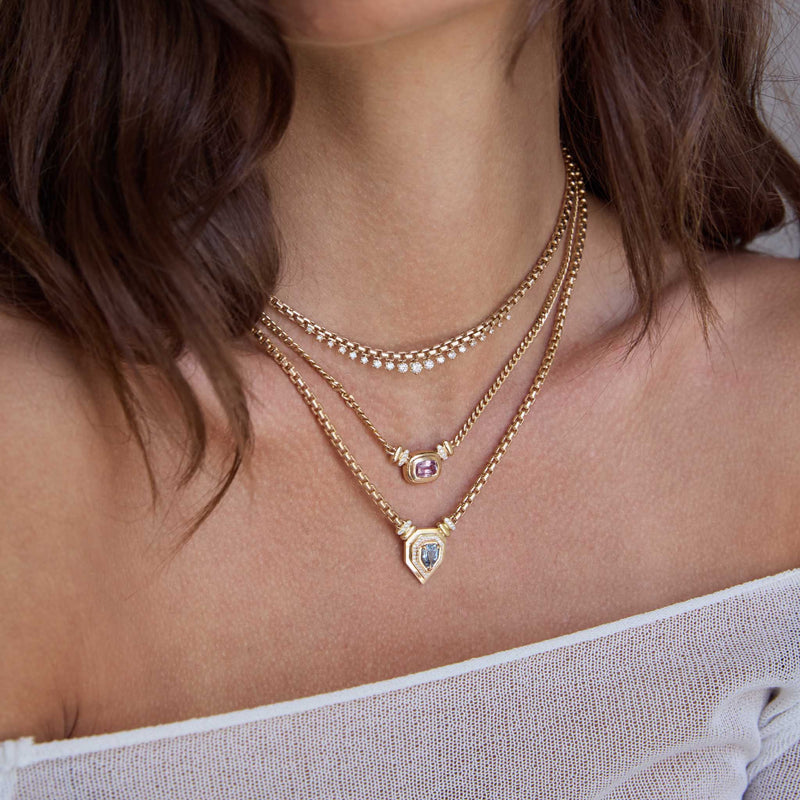 woman in an off shoulder sweater wearing a Zoë Chicco 14k Gold Graduated Prong Diamond Large Box Chain Necklace layered with two one of a kind sapphire gemstone necklaces