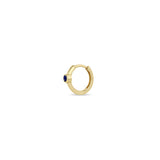 Angled view of a Zoë Chicco 14k Gold Single Blue Sapphire Bezel Small Hinge Huggie Hoop Earring