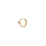 Angled view of a Zoë Chicco 14k Gold Single Ruby Bezel Small Hinge Huggie Hoop Earring