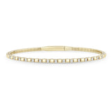 Zoe Chicco 14k gold alternating diamond and gold cube tennis bangle bracelet on a white background