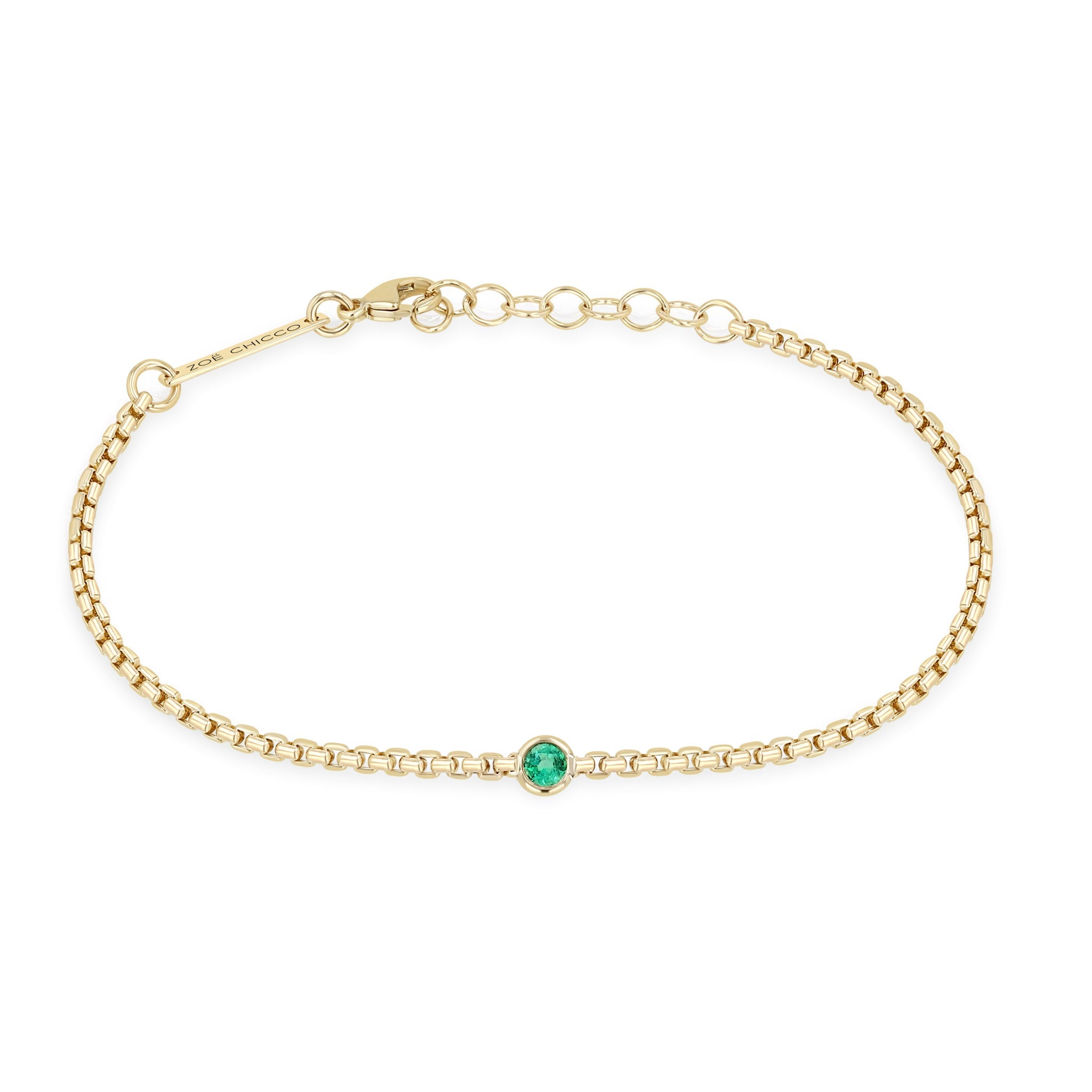 Zoe Chicco 14k gold chain bracelet with a single round emerald set in the center on a white background