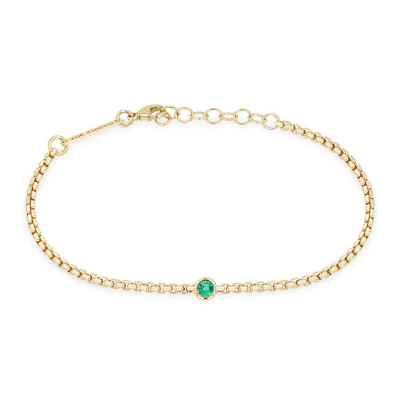 Zoe Chicco 14k gold chain bracelet with a single round emerald set in the center on a white background