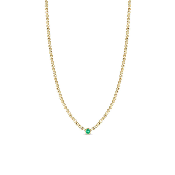 Zoe Chicco 14k gold chain necklace with a small round emerald gemstone in the center on a white background