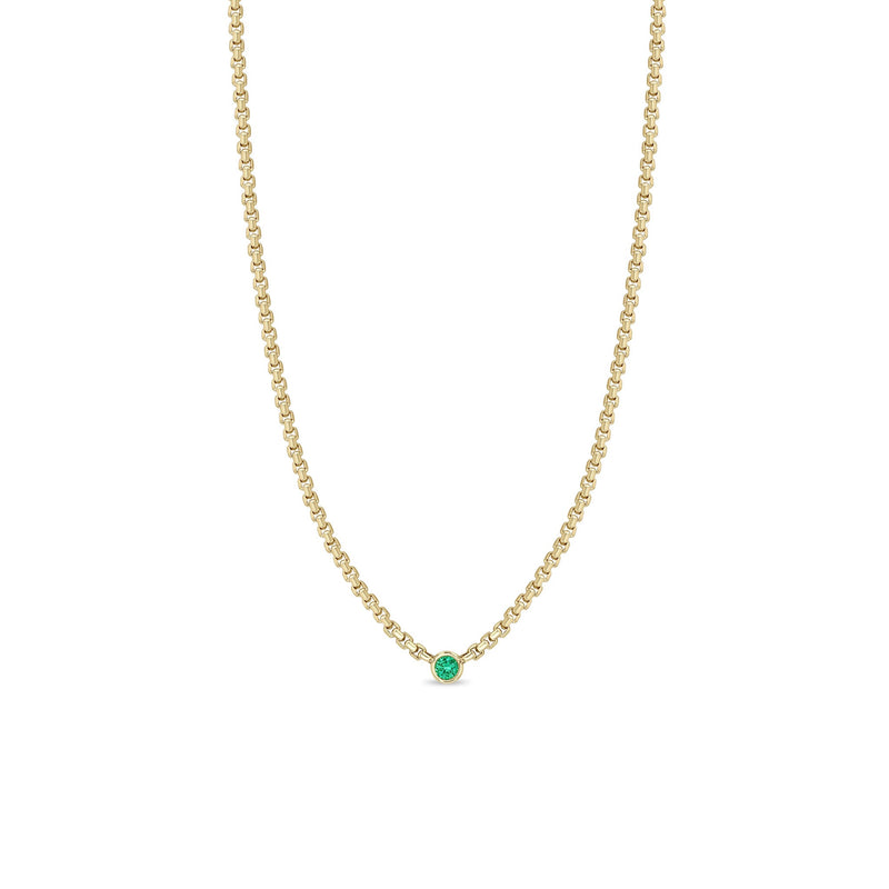 Zoe Chicco 14k gold chain necklace with a small round emerald gemstone in the center on a white background