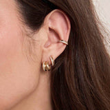 close up of a woman's ear wearing a Zoë Chicco 14k Gold & Pavé Diamond Double Row Huggie Hoop Earring in her second piercing and a 14k Gold & Pavé Diamond Line Double Chubby Huggie Hoop in her main piercing layered with a 14k Gold & Pavé Diamond Double Row Ear Cuff