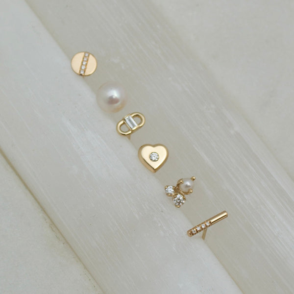 a variety of Zoe Chicco studs including: 14k Baguette Diamond Open Link Studs, 14k Diamond Nugget Heart Studs, 14k Mixed Prong Diamond & Pearl Cluster Stud Earrings, 14k Offset Pavé Diamond Bar Studs