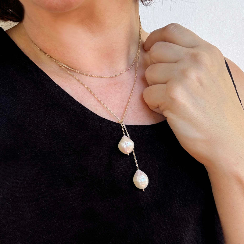 close up of a woman in a black tank top wearing a Zoë Chicco 14k Gold Double Baroque Pearl Wrap Around Lariat Necklace wrapped around twice