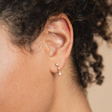 A Zoe Chicco drop earring with 3 graduated prong diamonds.