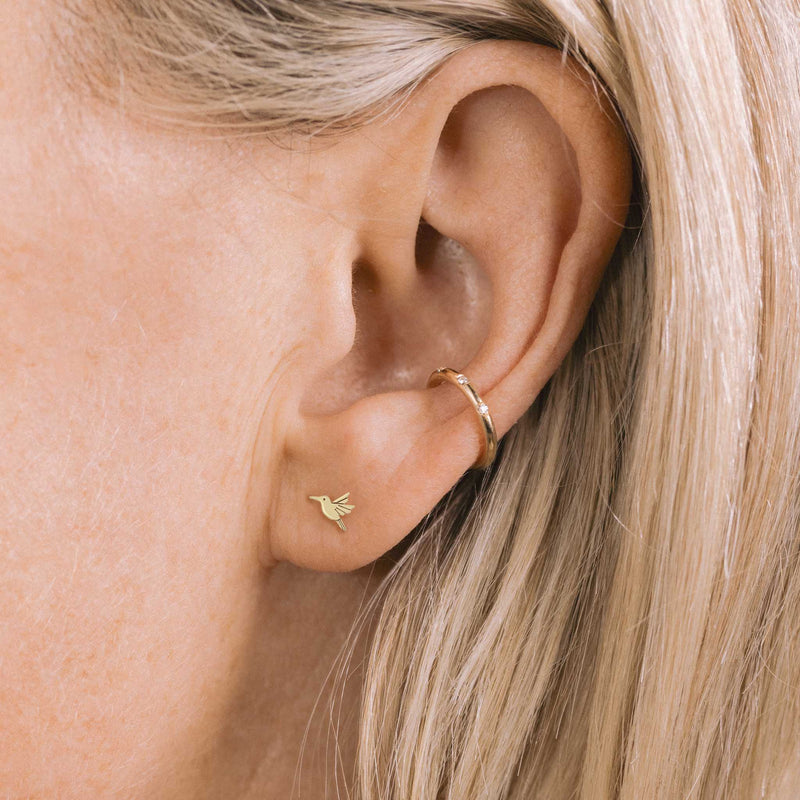 woman wearing a Zoë Chicco 14k Gold Itty Bitty Hummingbird Stud Earring for the Left Ear