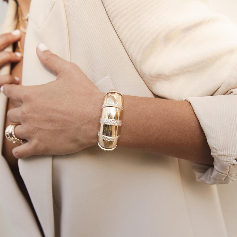 woman in a cream blazer wearing a Zoë Chicco 14k Yellow Gold Pavé Diamond Banded Large Aura Cuff Bracelet on her wrist