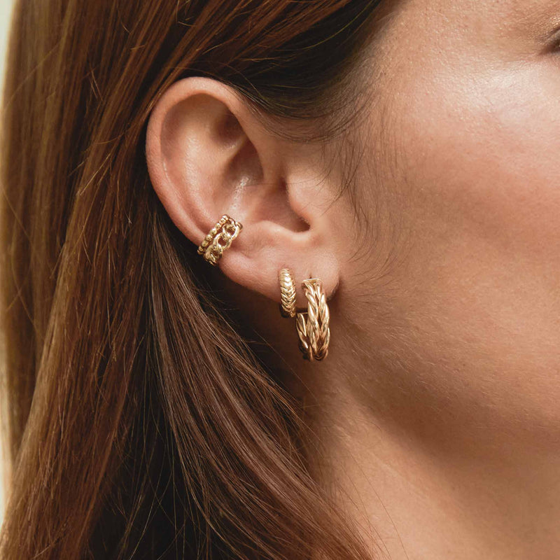 a woman's ear wearing a Zoe Chicco 1k Gold Beaded Ear Cuff layered with a 14k Medium Curb Chain Ear Cuff